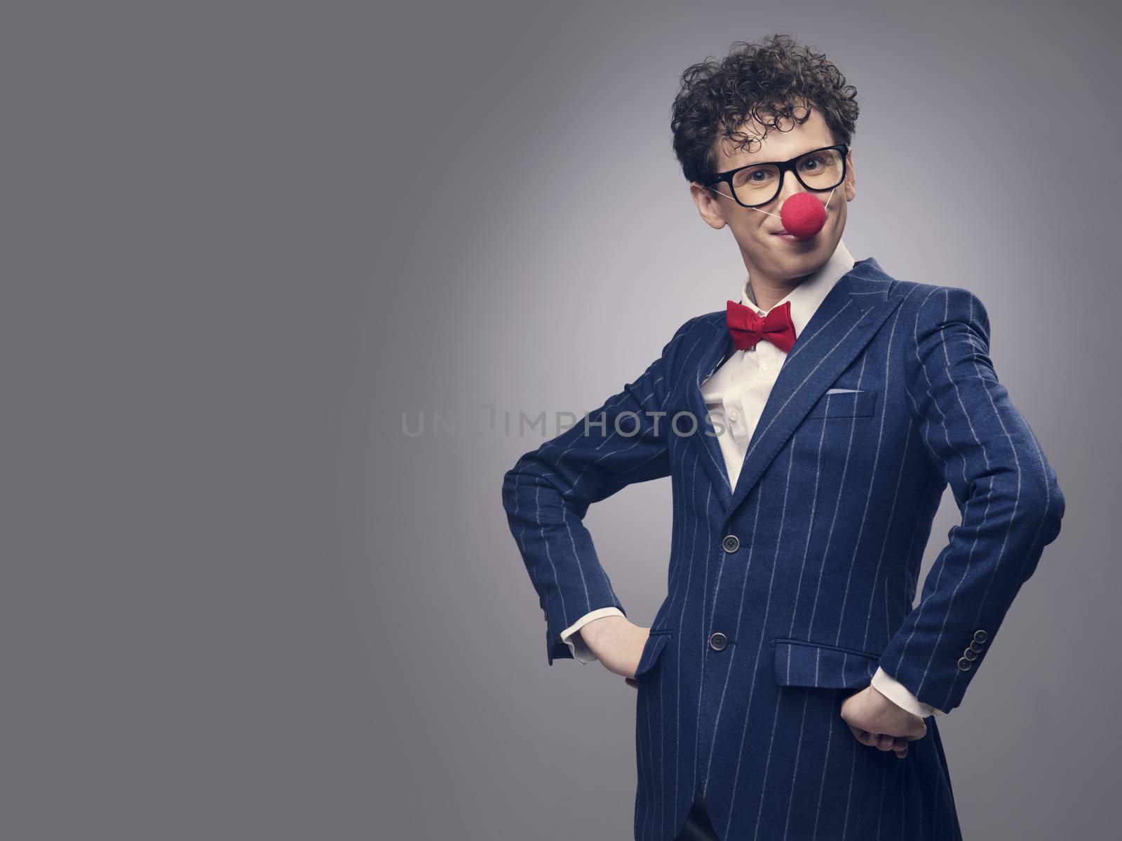 Funny businessman wearing red clown nose