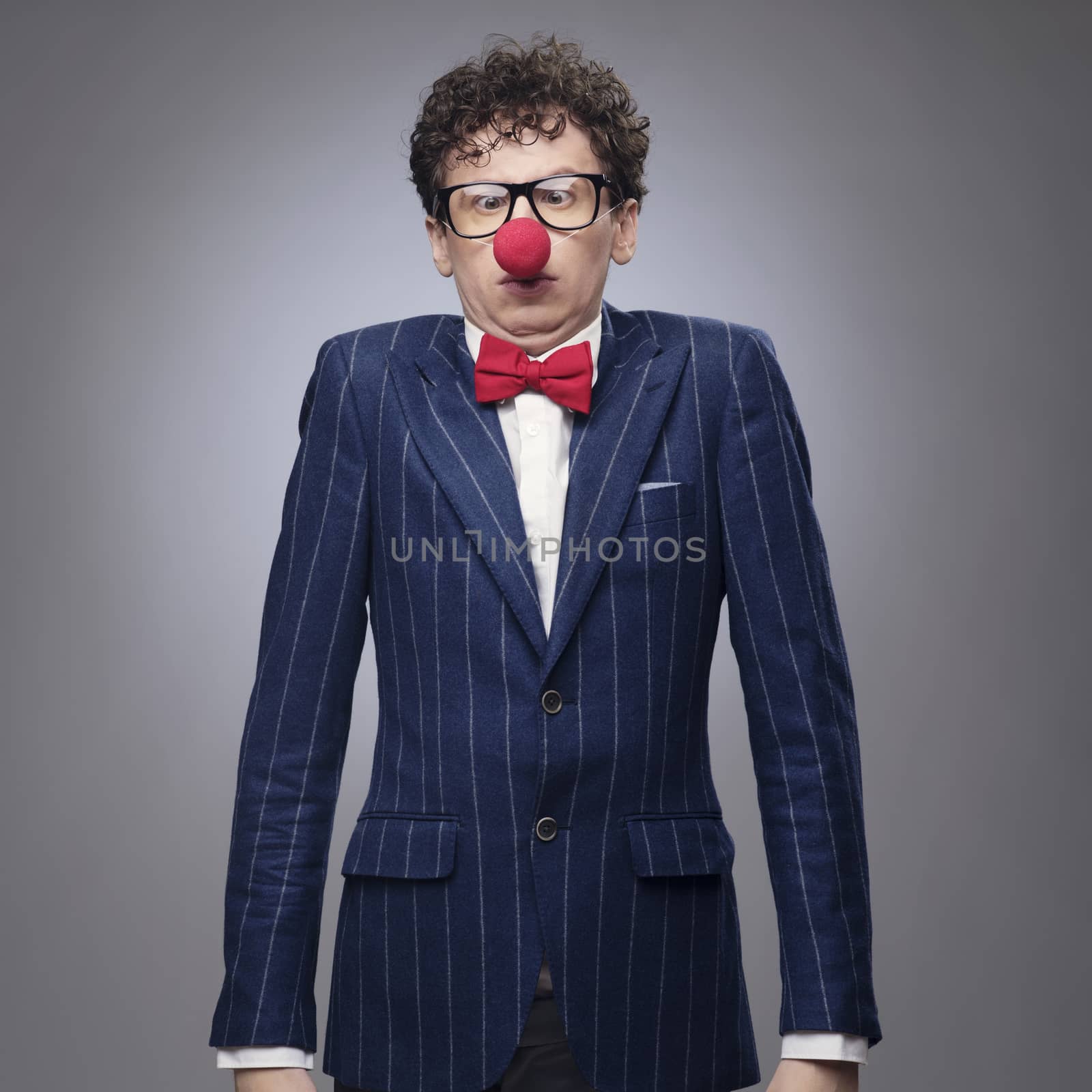 Funny businessman wearing red clown nose
