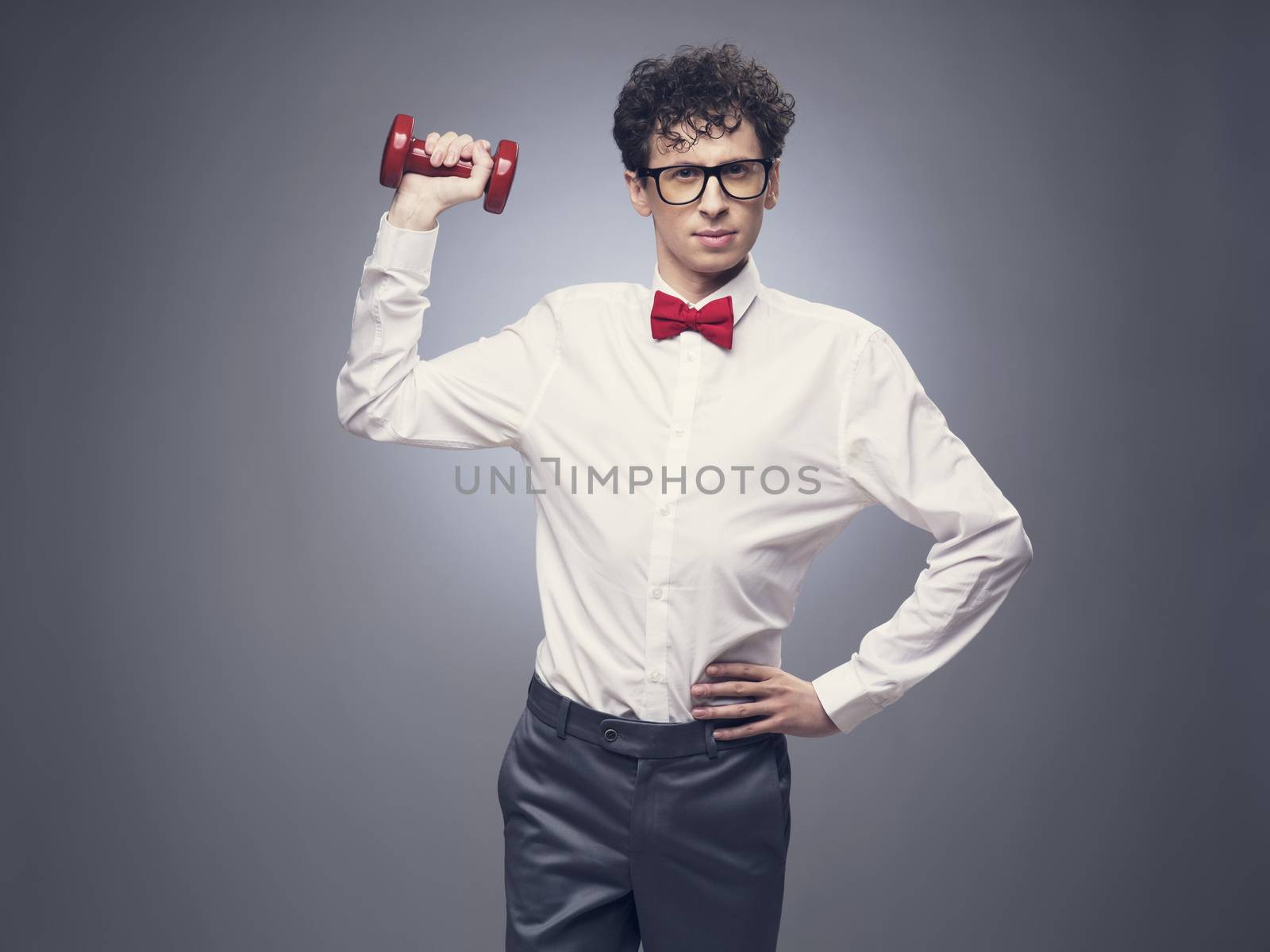 Funny skinny man lifting weights and look proud about it