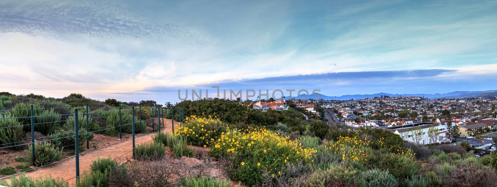 Hiking trail above Dana Point city view at sunset by steffstarr