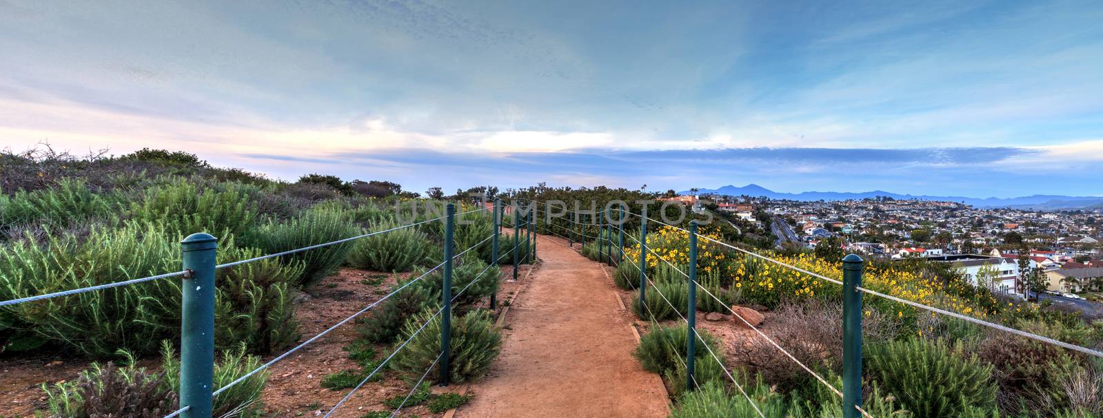 Hiking trail above Dana Point city view at sunset in Southern California, USA