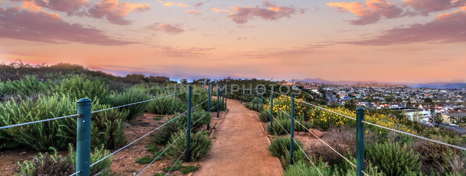 Hiking trail above Dana Point city view at sunset in Southern California, USA