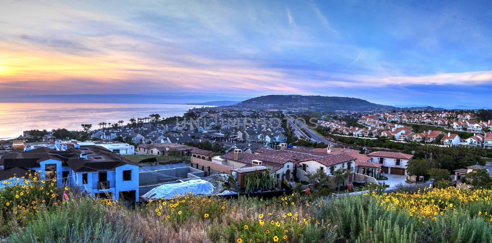 Hiking trail above Dana Point coast and the ocean at sunset in Southern California, USA