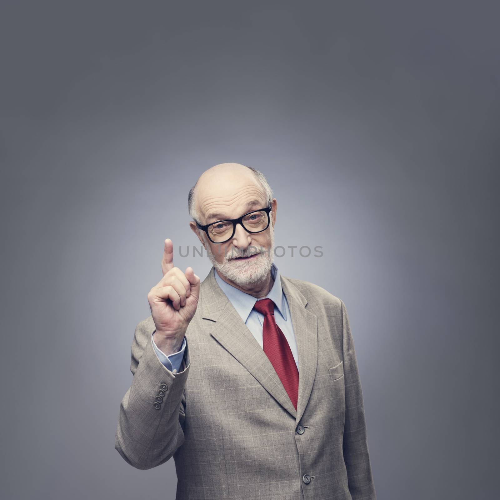 Senior man points finger up by ALotOfPeople