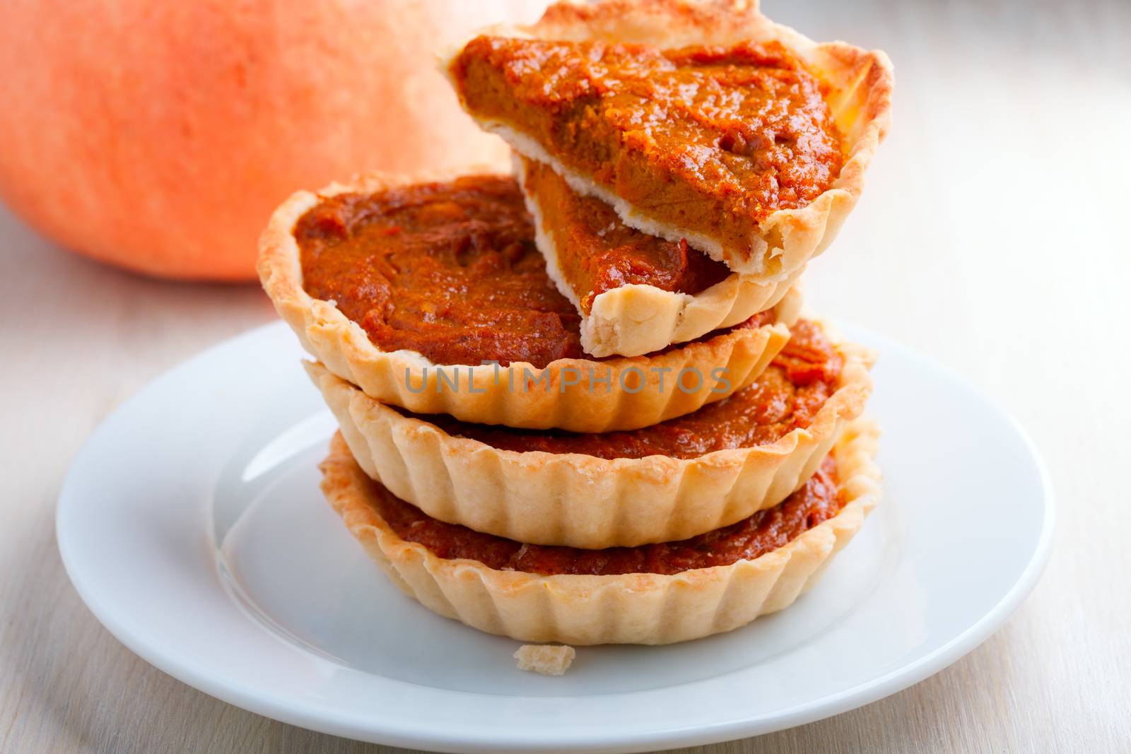 Pumpkin and Pumpkin pie dessert on a wooden surface