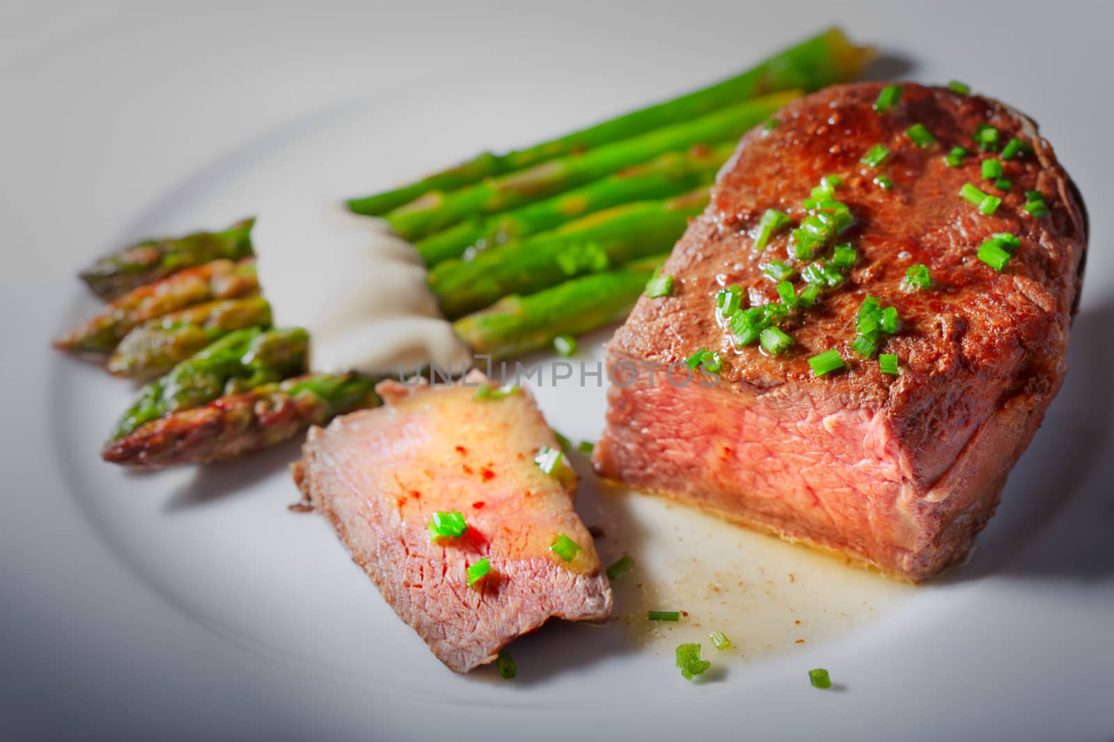 Grilled Beef with Asparagus on a white plate