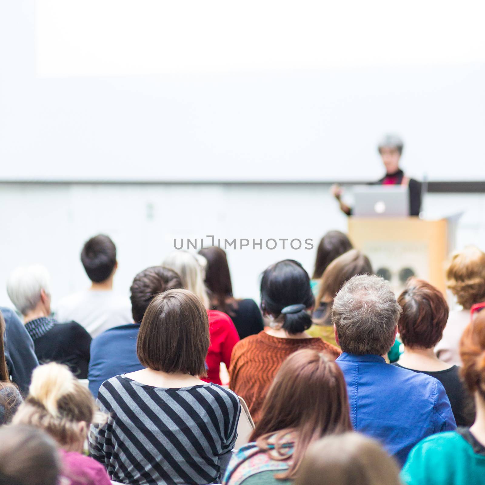 Woman giving presentation on business conference. by kasto