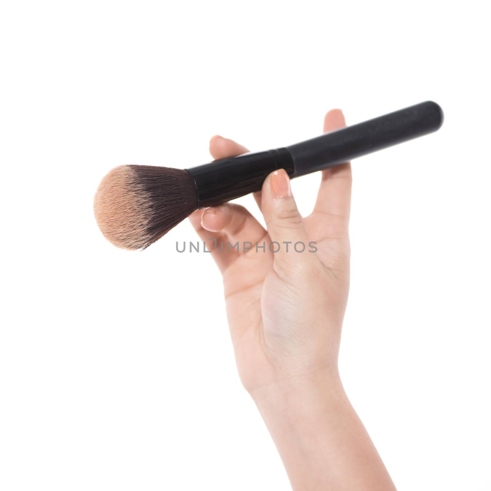 Professional make-up brush cosmetic in female hand isolated on white