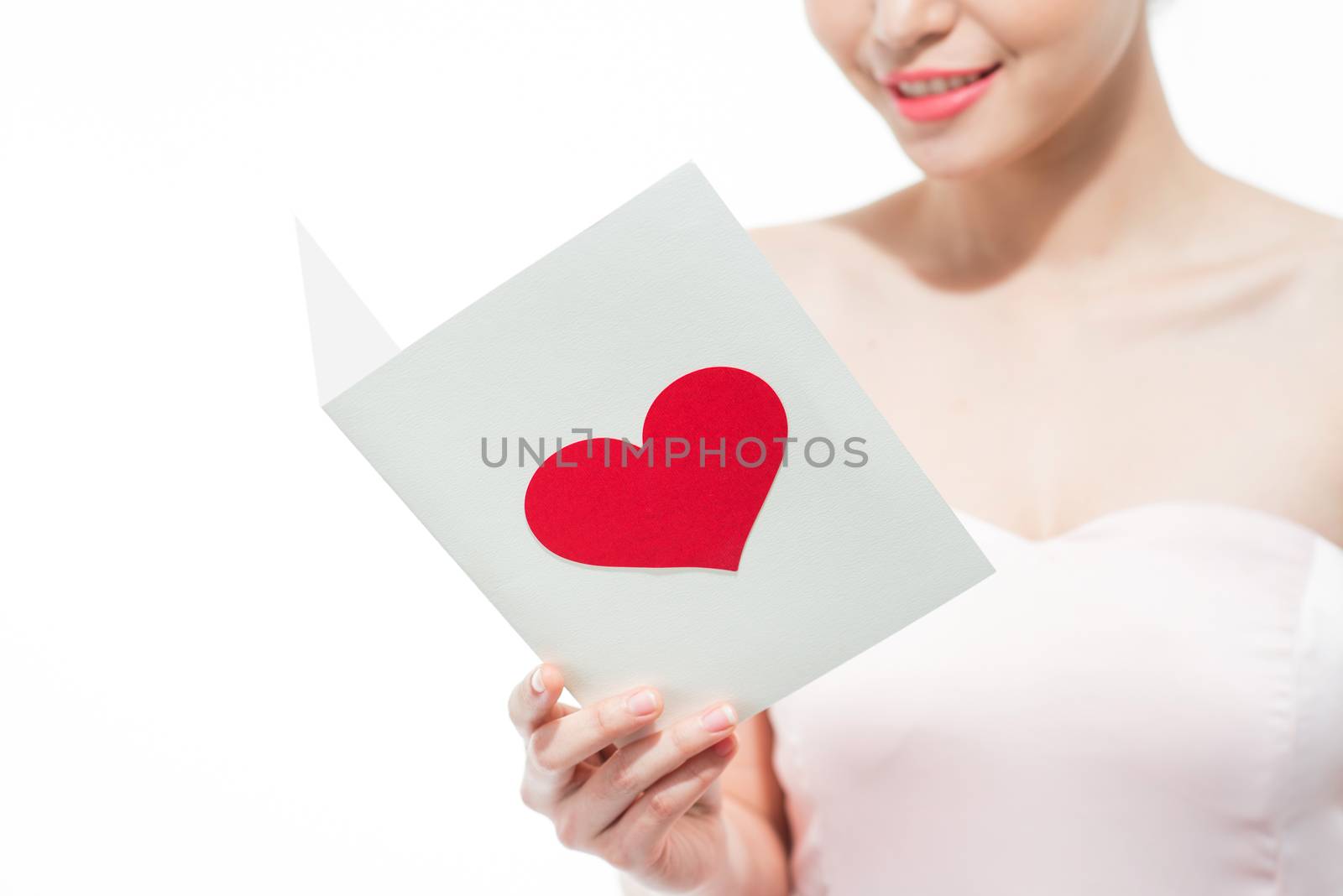 Happy beautiful young woman reading love greeting card.