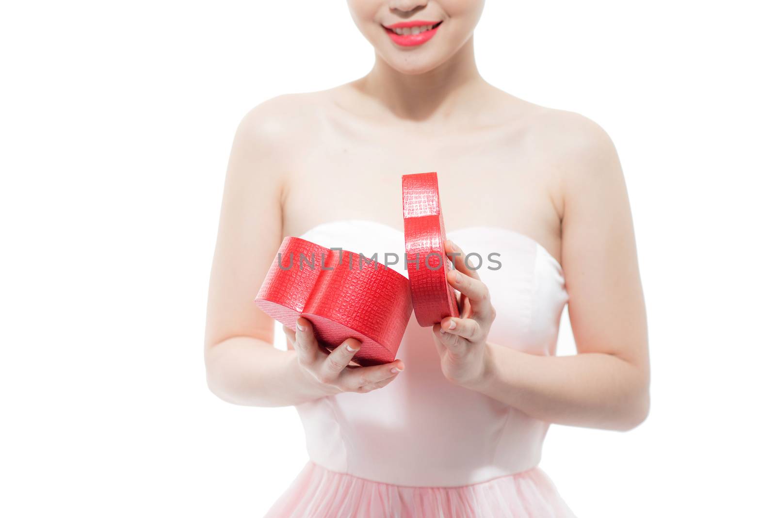 Happy beautiful young woman opening heart shape red gift box by makidotvn