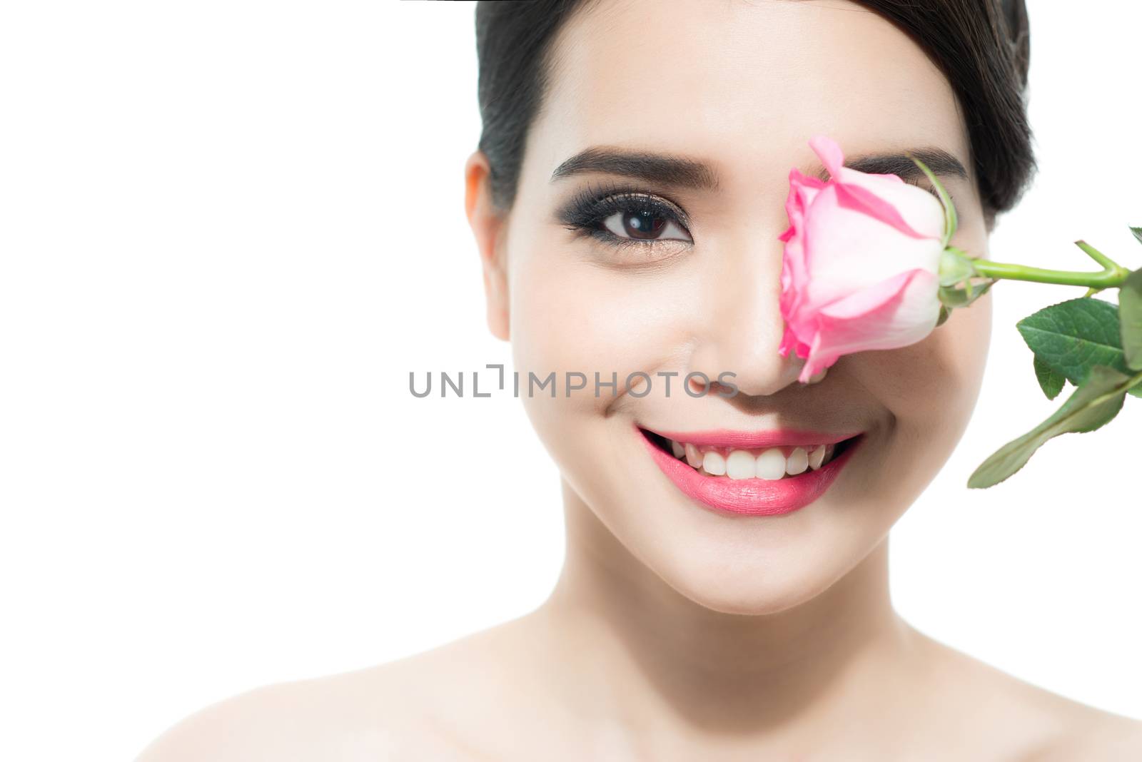 Copy-spaced portrait of a beautiful lady with a rose flower over a white background. Woman day concept. Closeup fresh face girl.