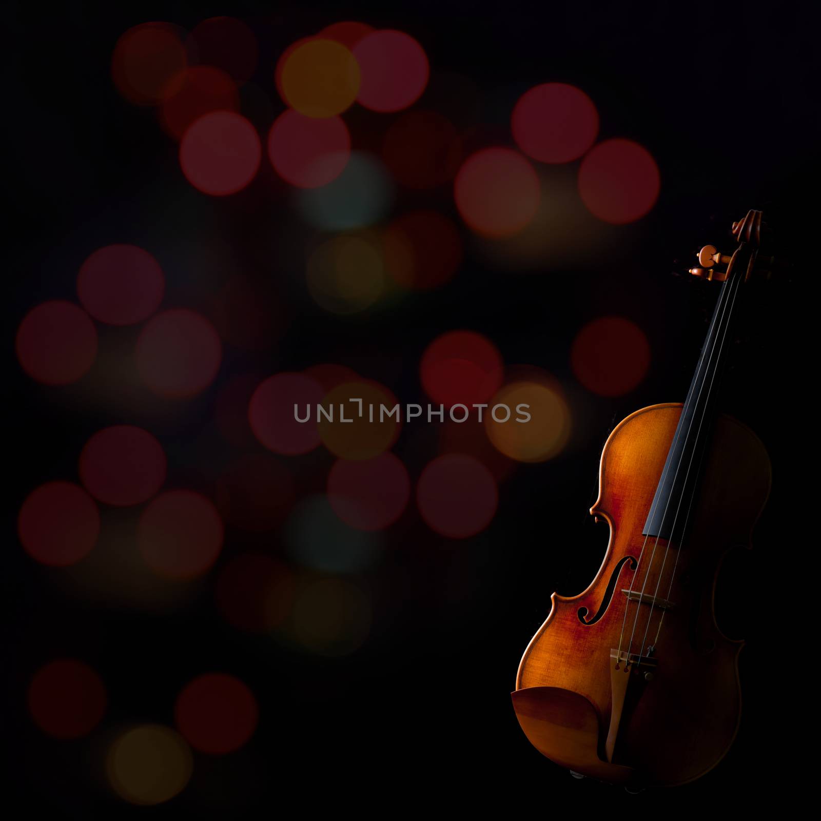 Beautiful vintage violin on blurry bokeh background.