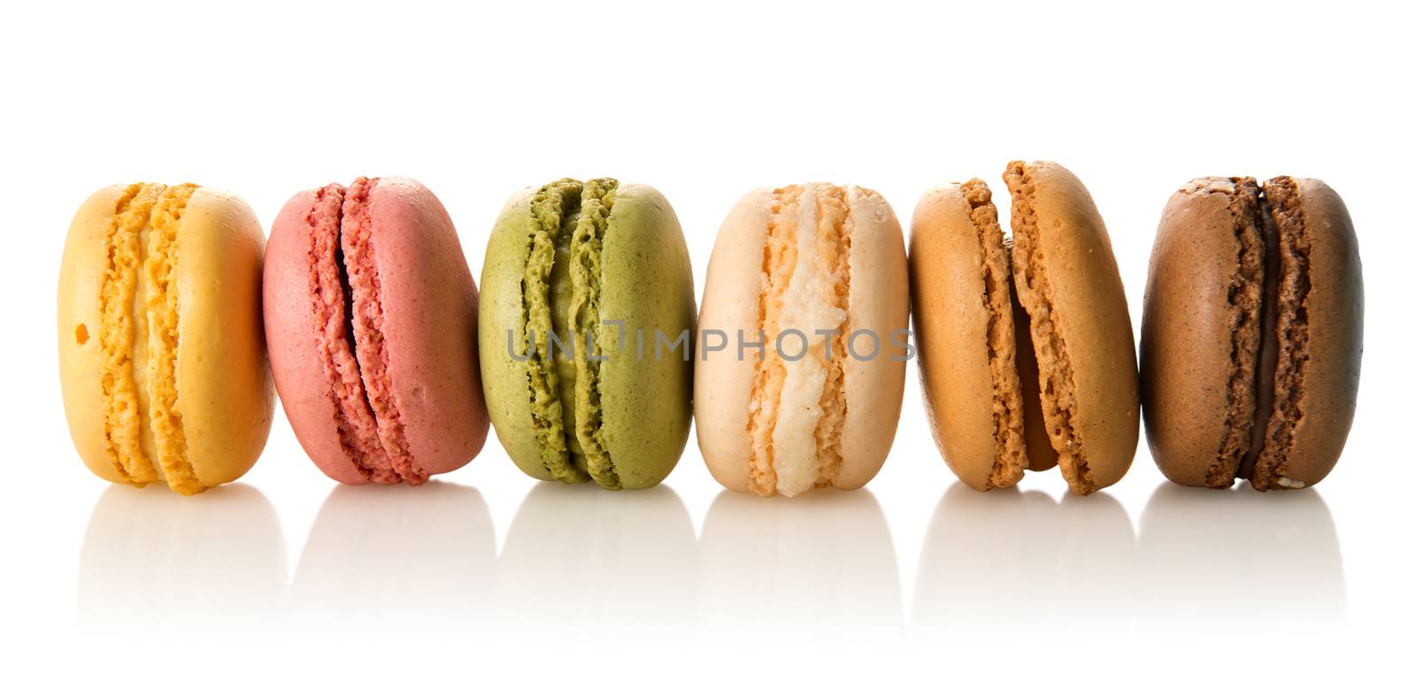 Row of colorful sweet macarons isolated on a white background