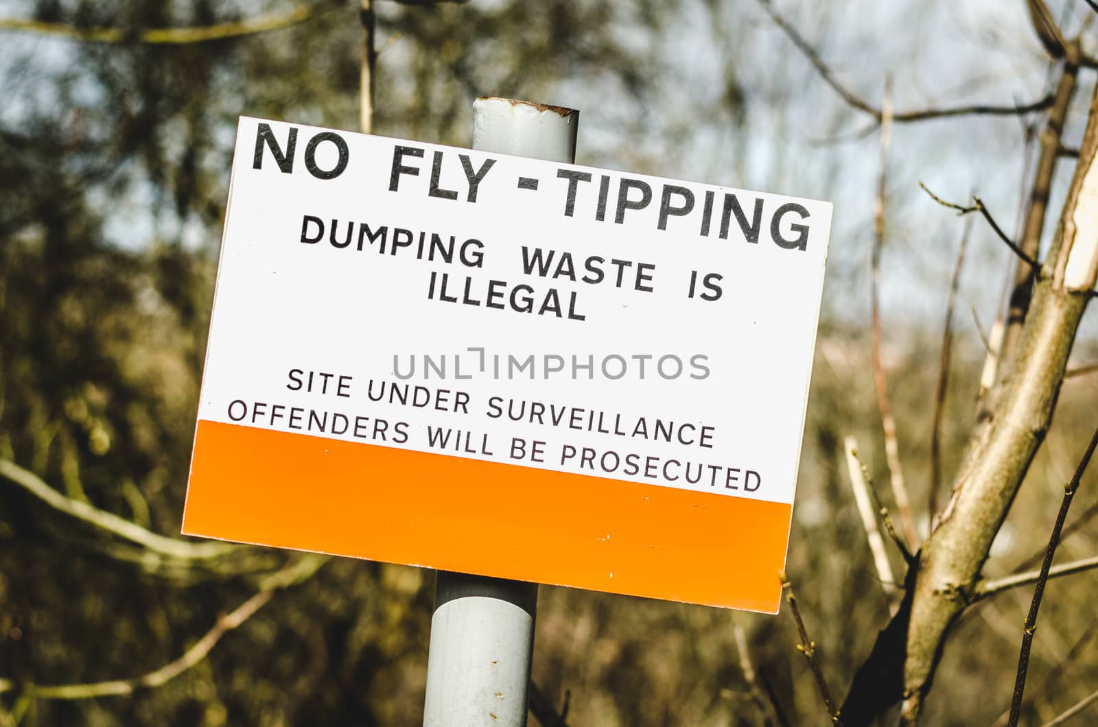 A sign in England, UK warning that dumping of trash in the area is illegal and offenders will be prosecuted. Surveillance site.