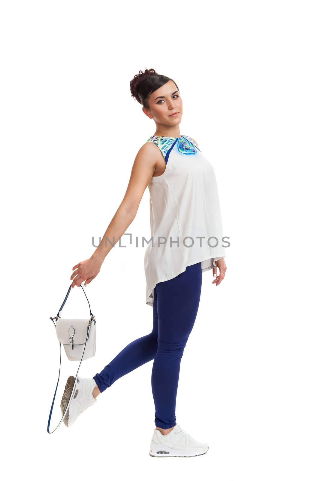 the young woman in convenient clothes with a bag on a white background