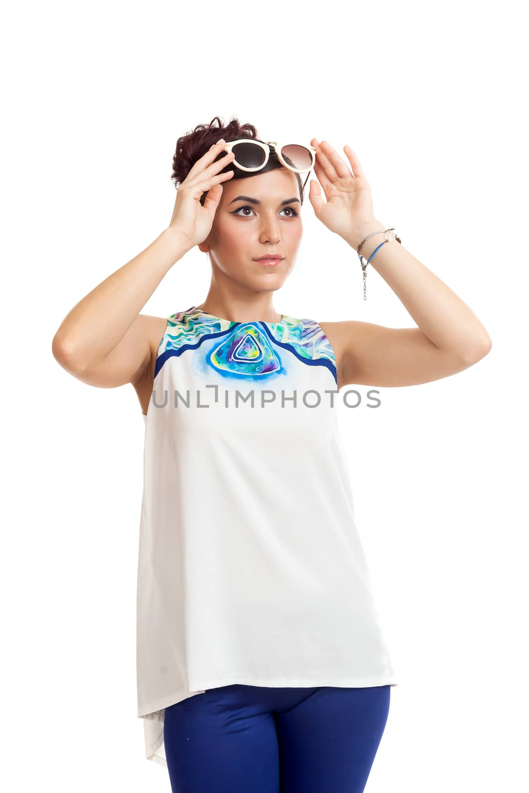 the young woman in sunglasses and in convenient clothes on a white background