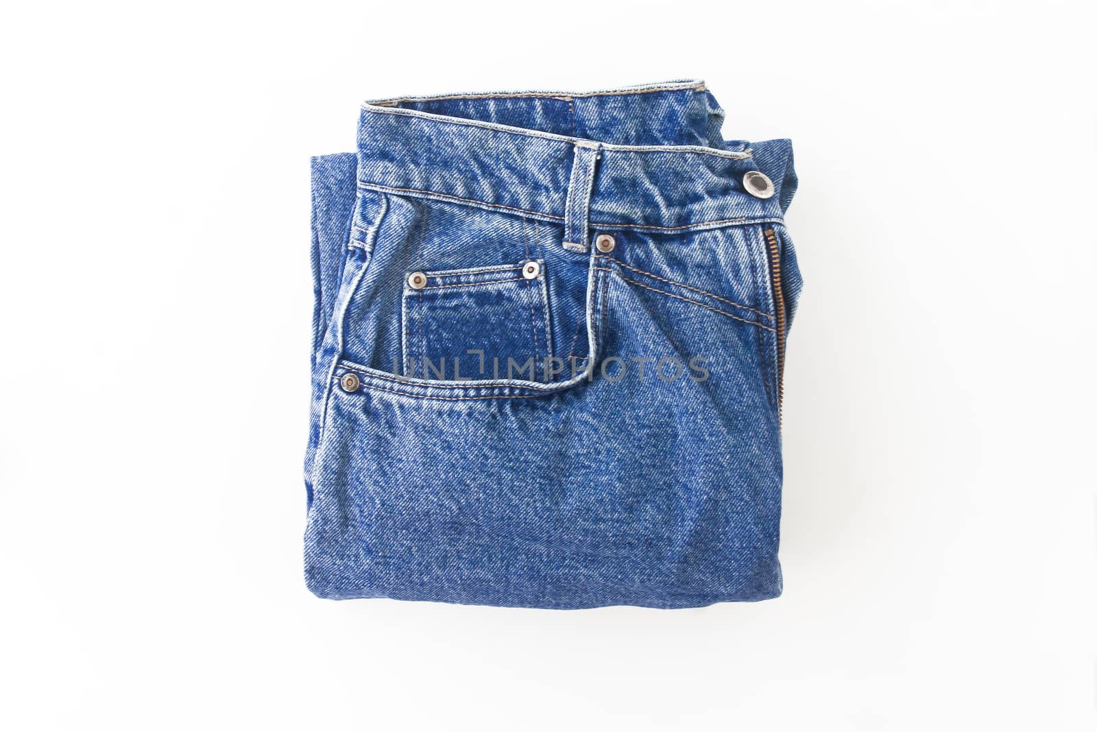 Light blue retro jeans neatly folded, isolated.