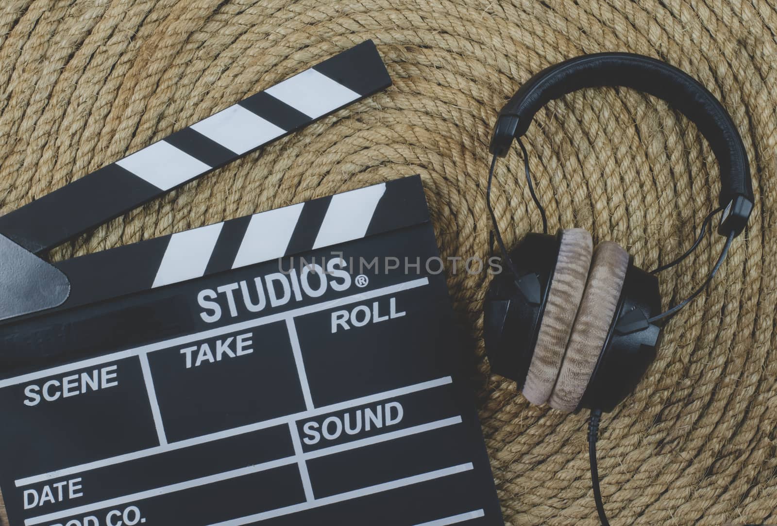 Slate film and headphone  on a jute rope background