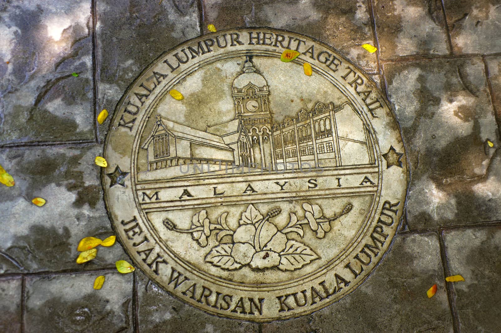 KUALA LUMPUR, MALAYSIA - JANUARY 16, 2016: a round memorial pate on ground - symbol of the city.