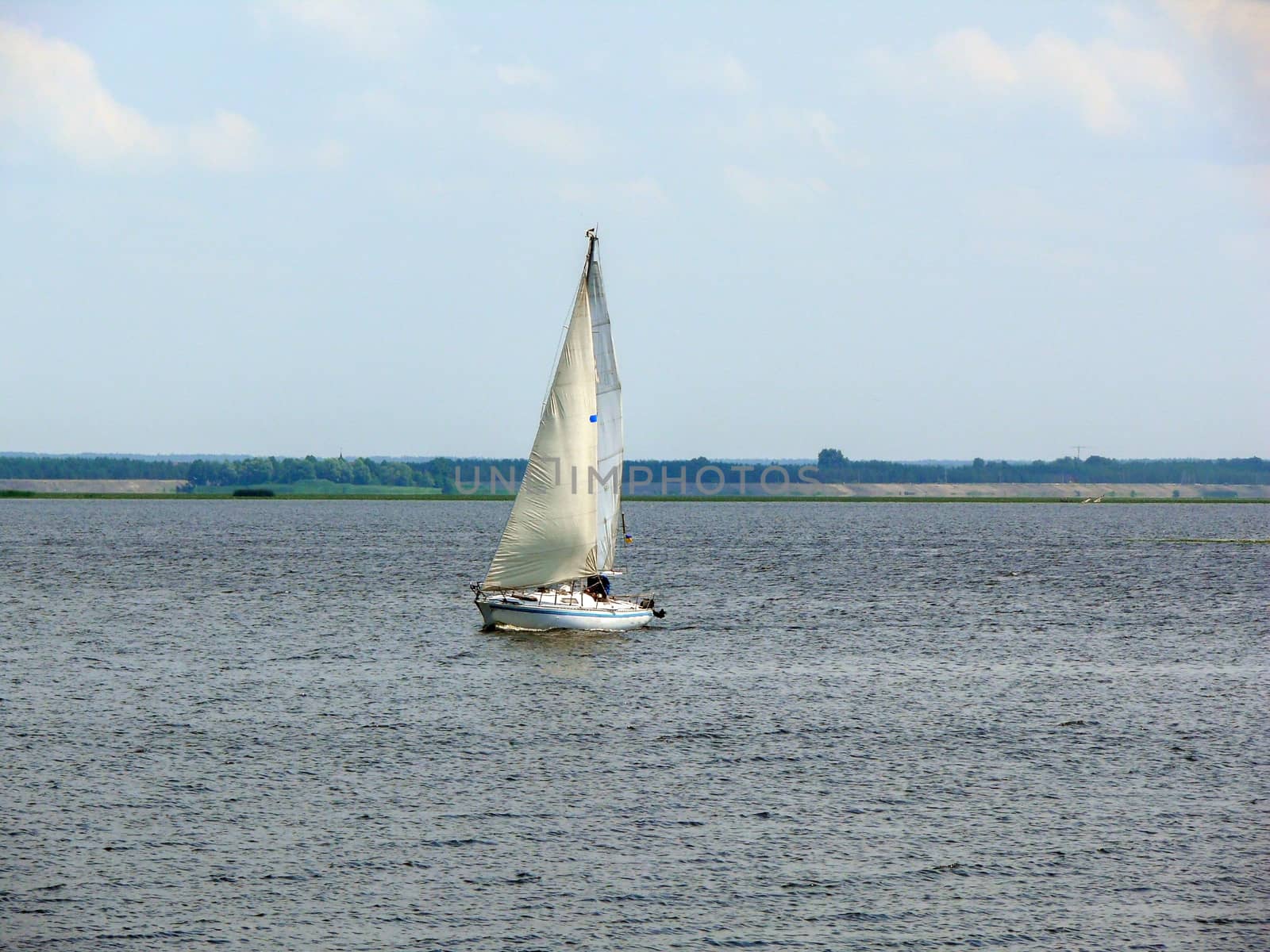 Sailboat on a lake at sunny day, Ukraine by evolutionnow