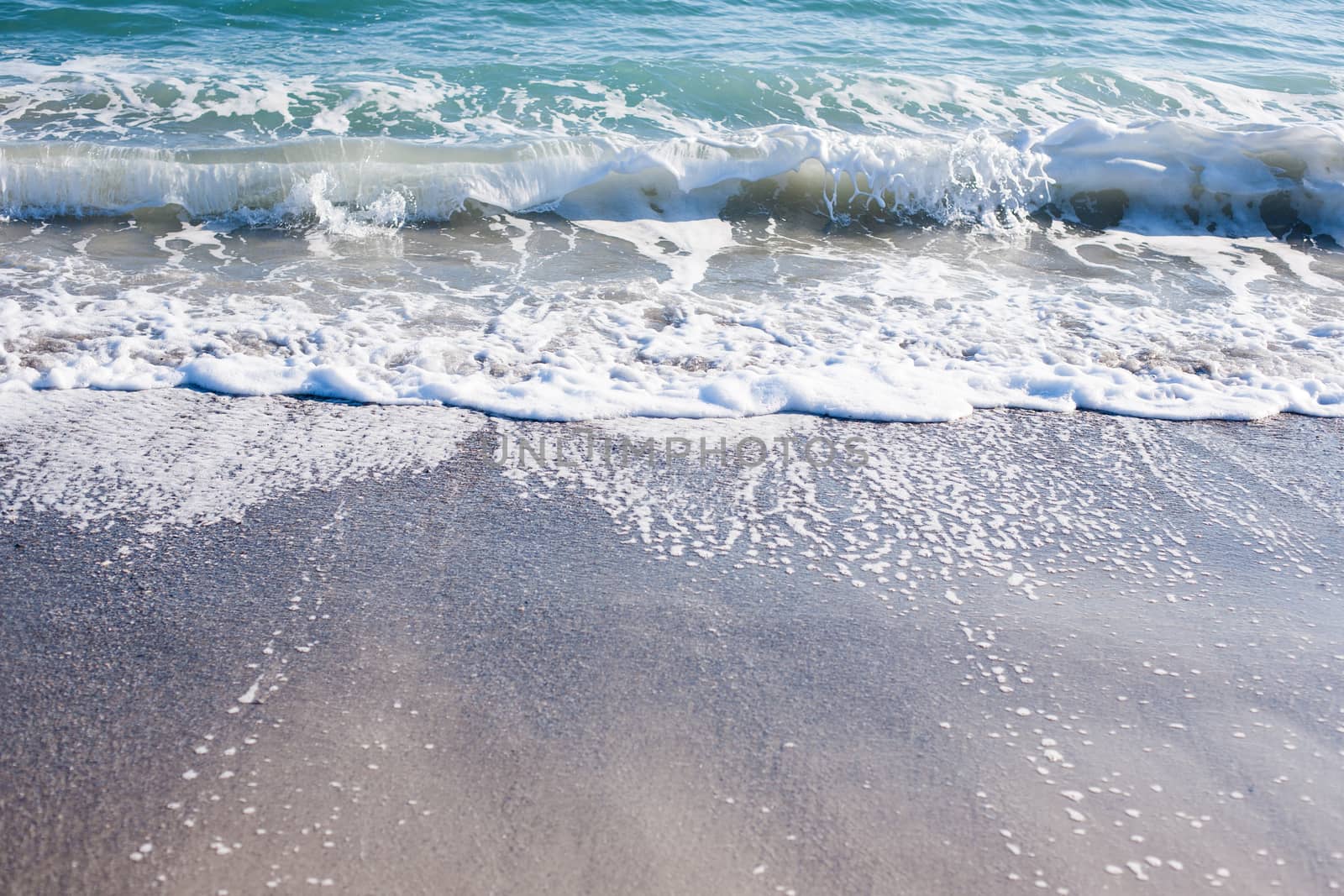 Soft wave of Black sea on sandy beach. Nature Background