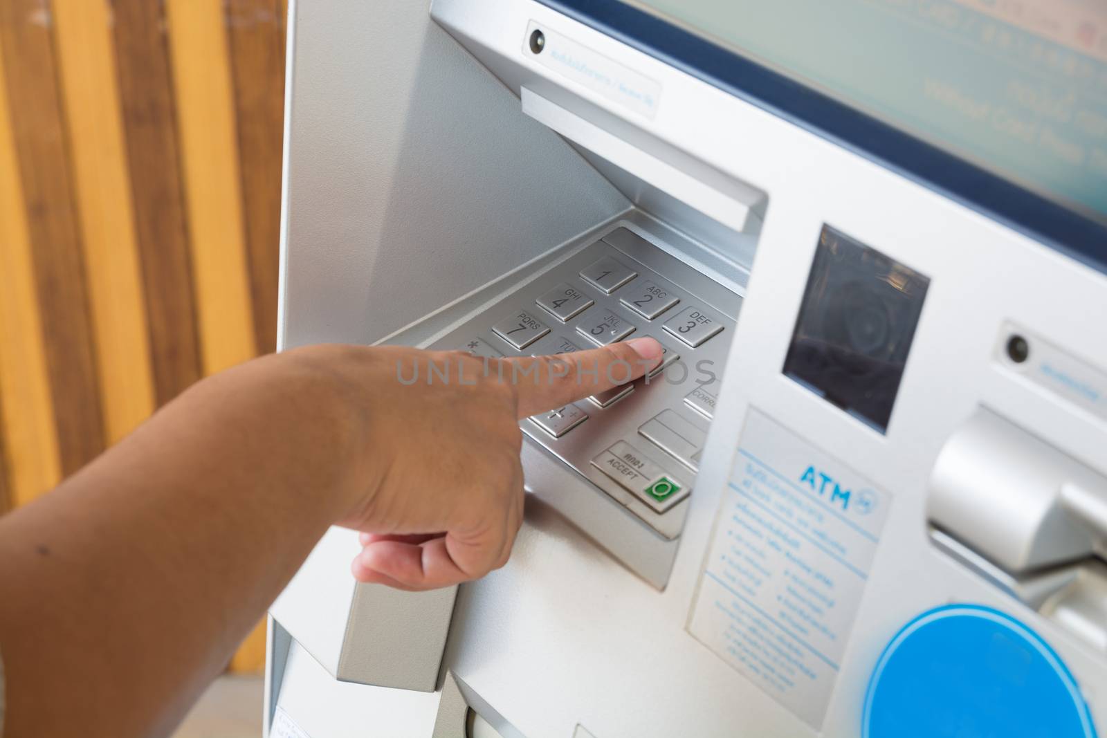 Keyboard Panel of ATM or Autmatic Teller Machine with Female Hand Push ATM Security Pin Code or Password to make Transaction as Modern Financial Technology Security Concept