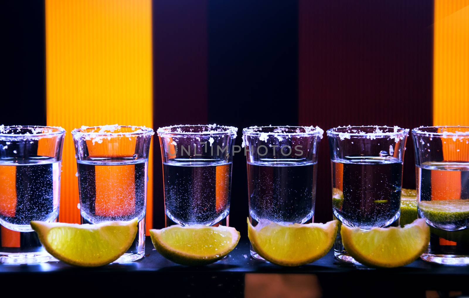 Shot drink set with citrus slices on bar background