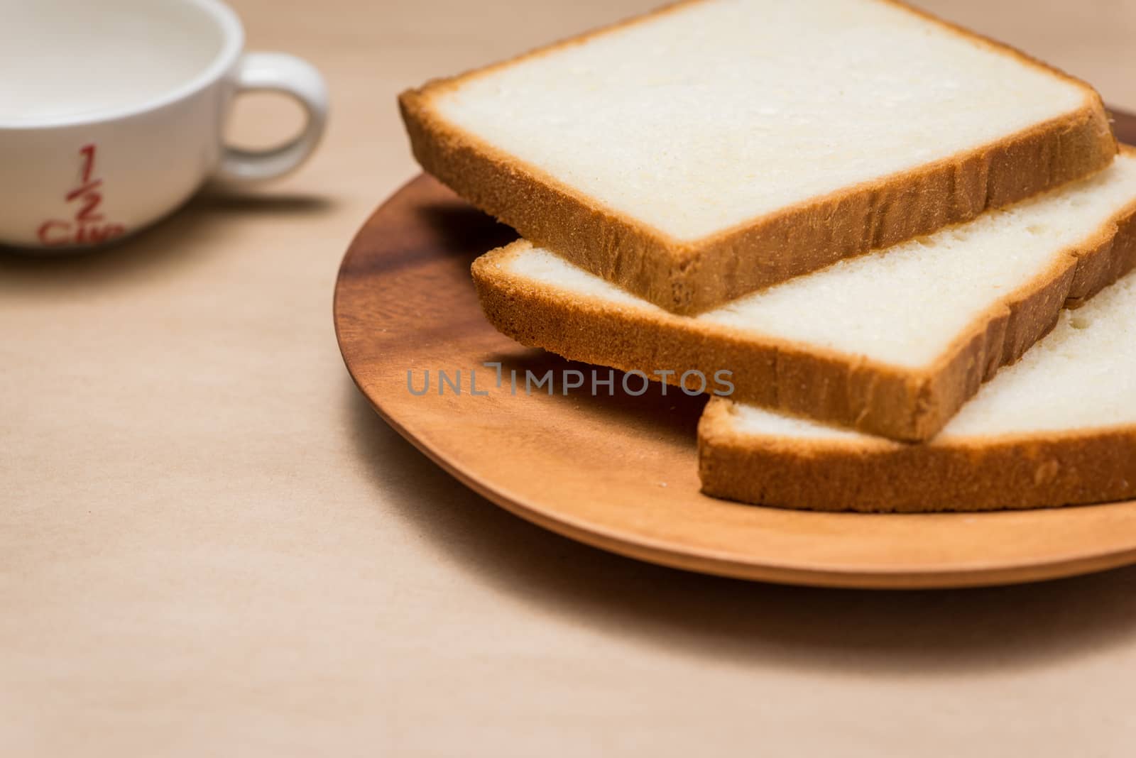 Close-up of slice of toast bread on wood table