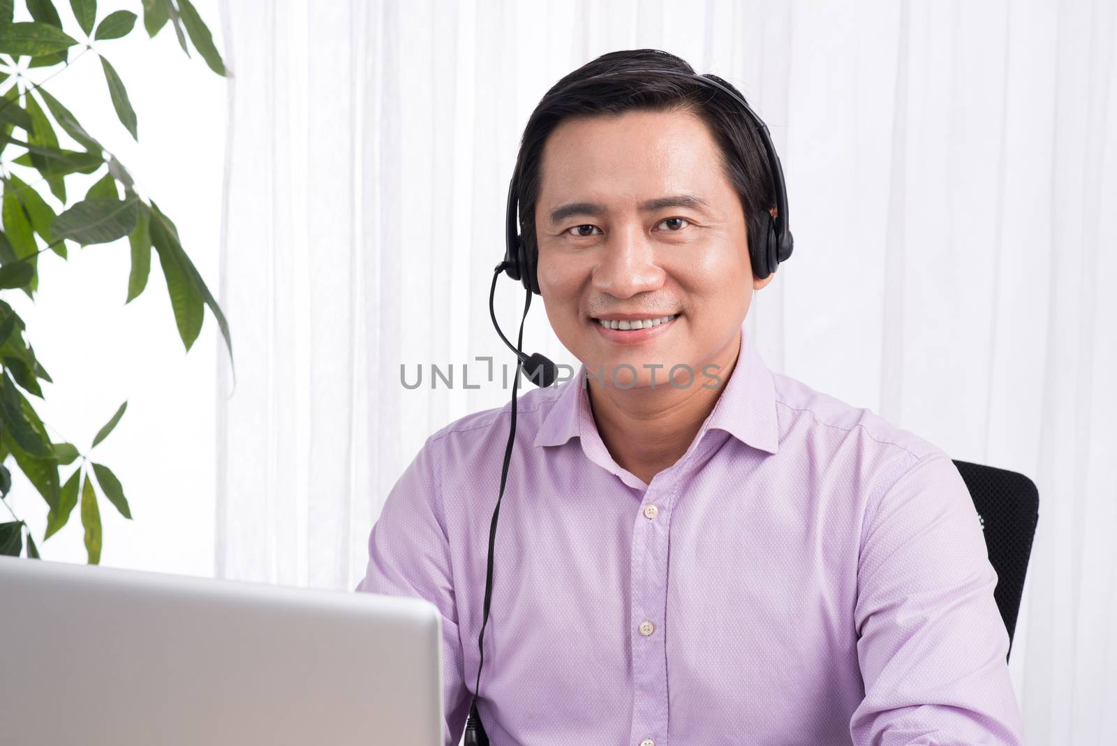 Portrait of handsome asian hotline person consultant wearing headset