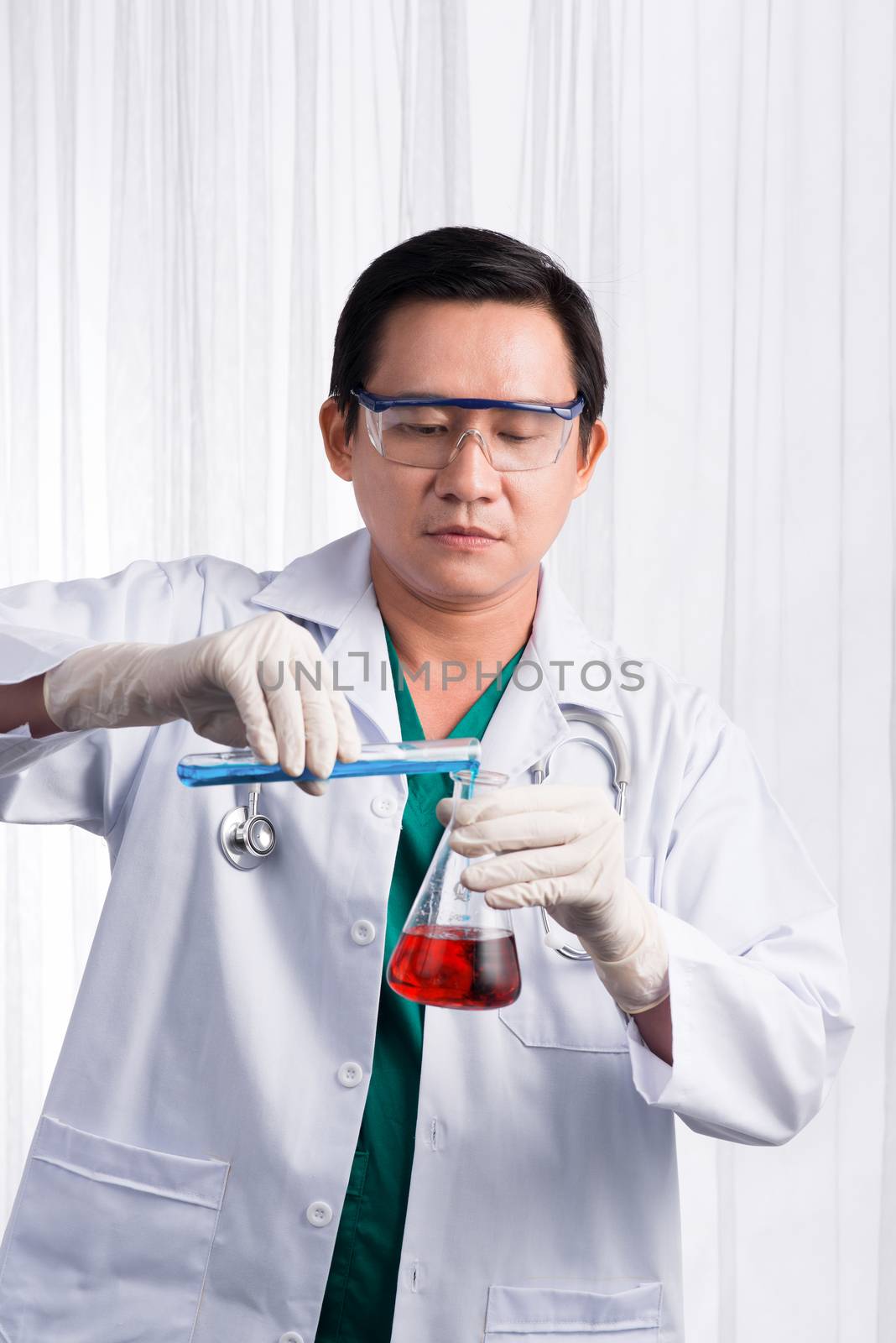 Male scientist holds and examine samples by makidotvn