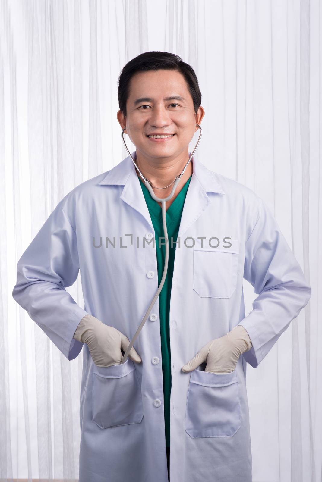 Male Doctor with stethoscope in a hospital by makidotvn