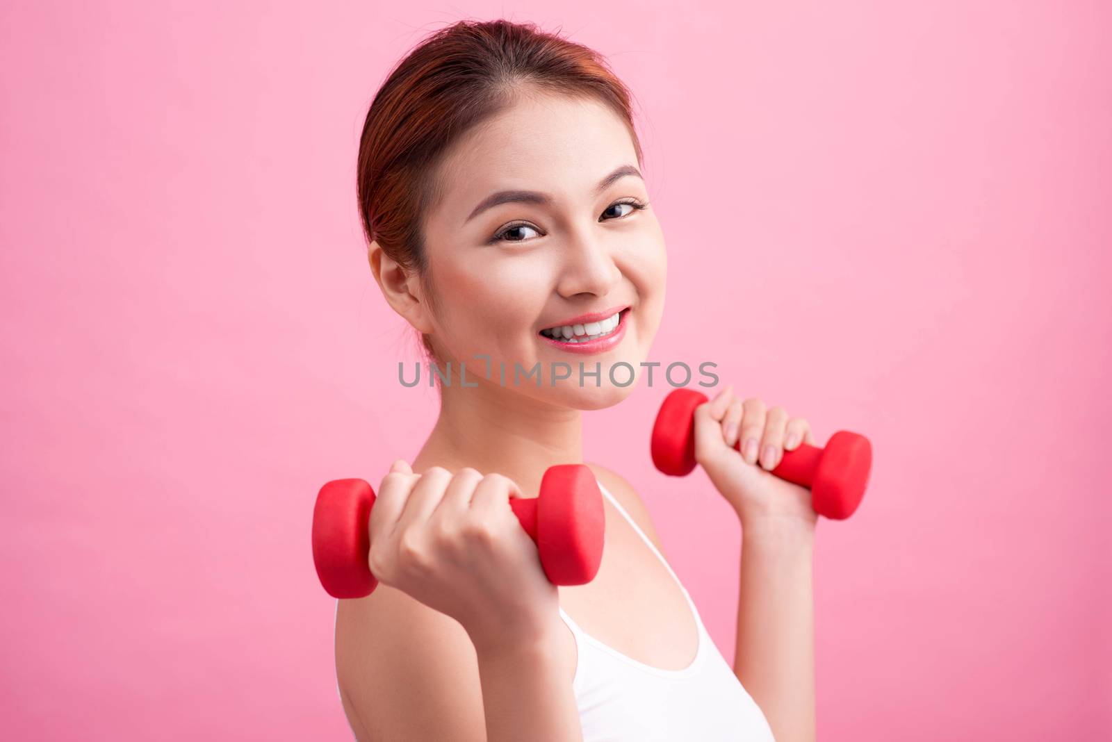 Woman Lifting Weights. Fitness woman lifting weights smiling hap by makidotvn