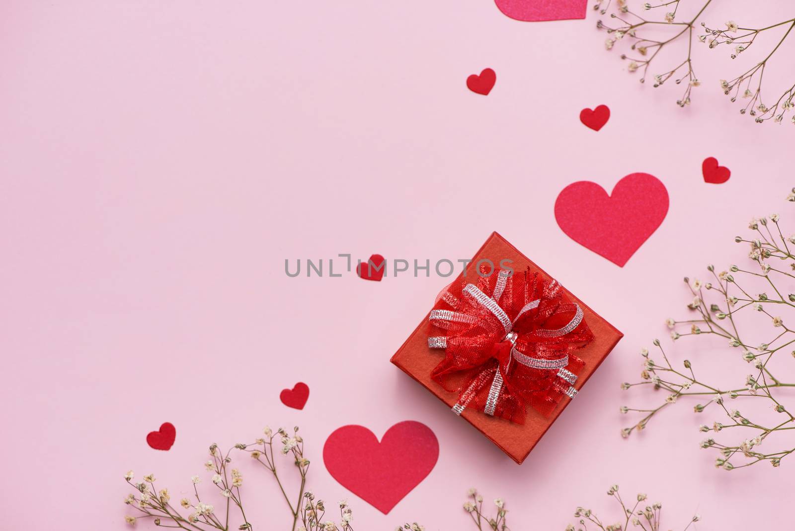 Red gift boxes tied with ribbon and white flowers for mothers day