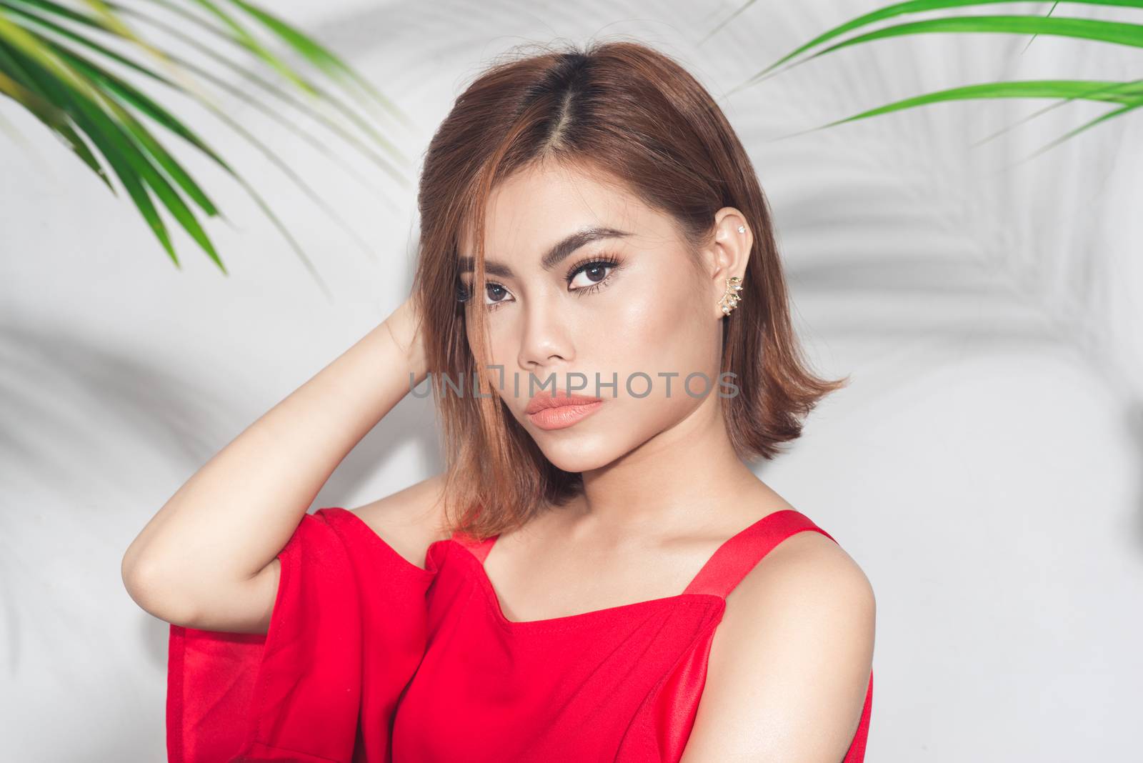 Summer beauty concept. Portrait of young asian woman in red dress