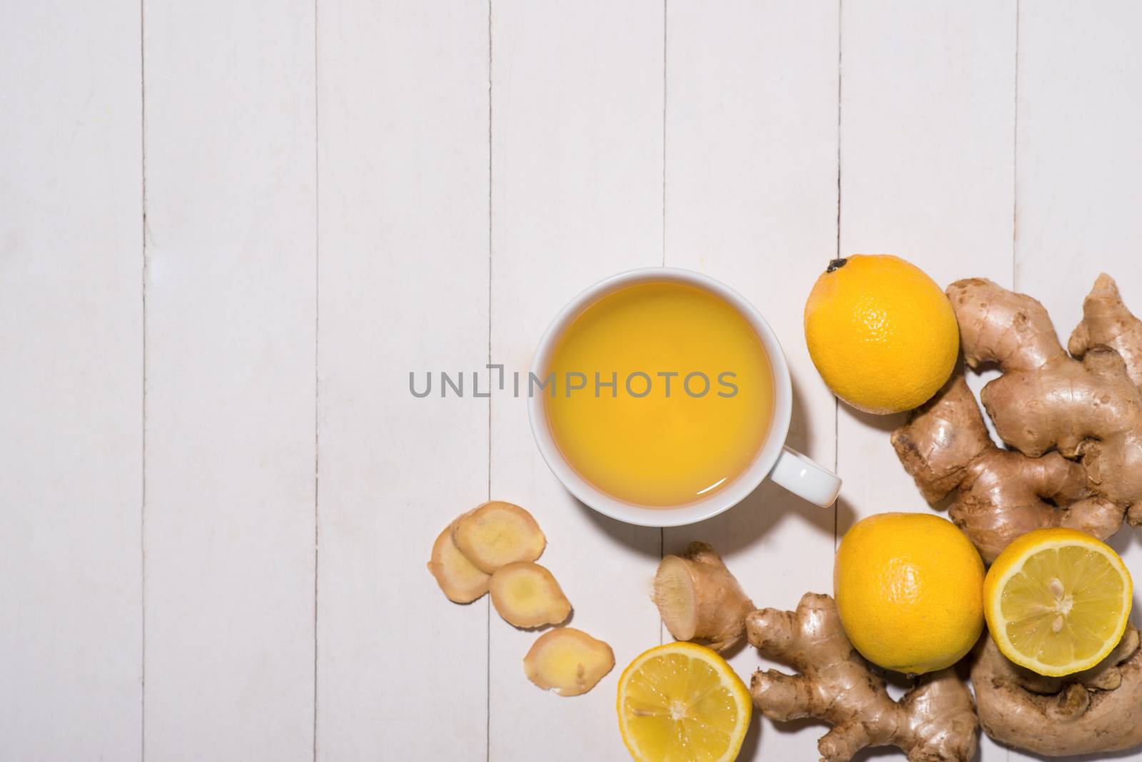 Healthy ginger tea ingredients on a wooden table