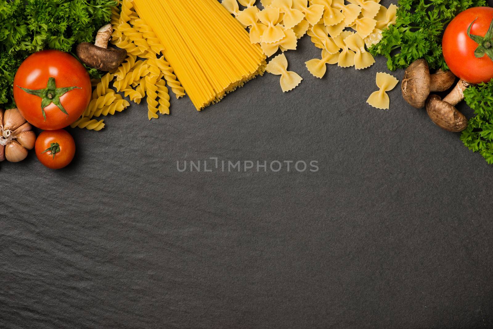 Italian food concept. Pasta ingredients. Cherry-tomatoes, spaghetti pasta, rosemary and spices