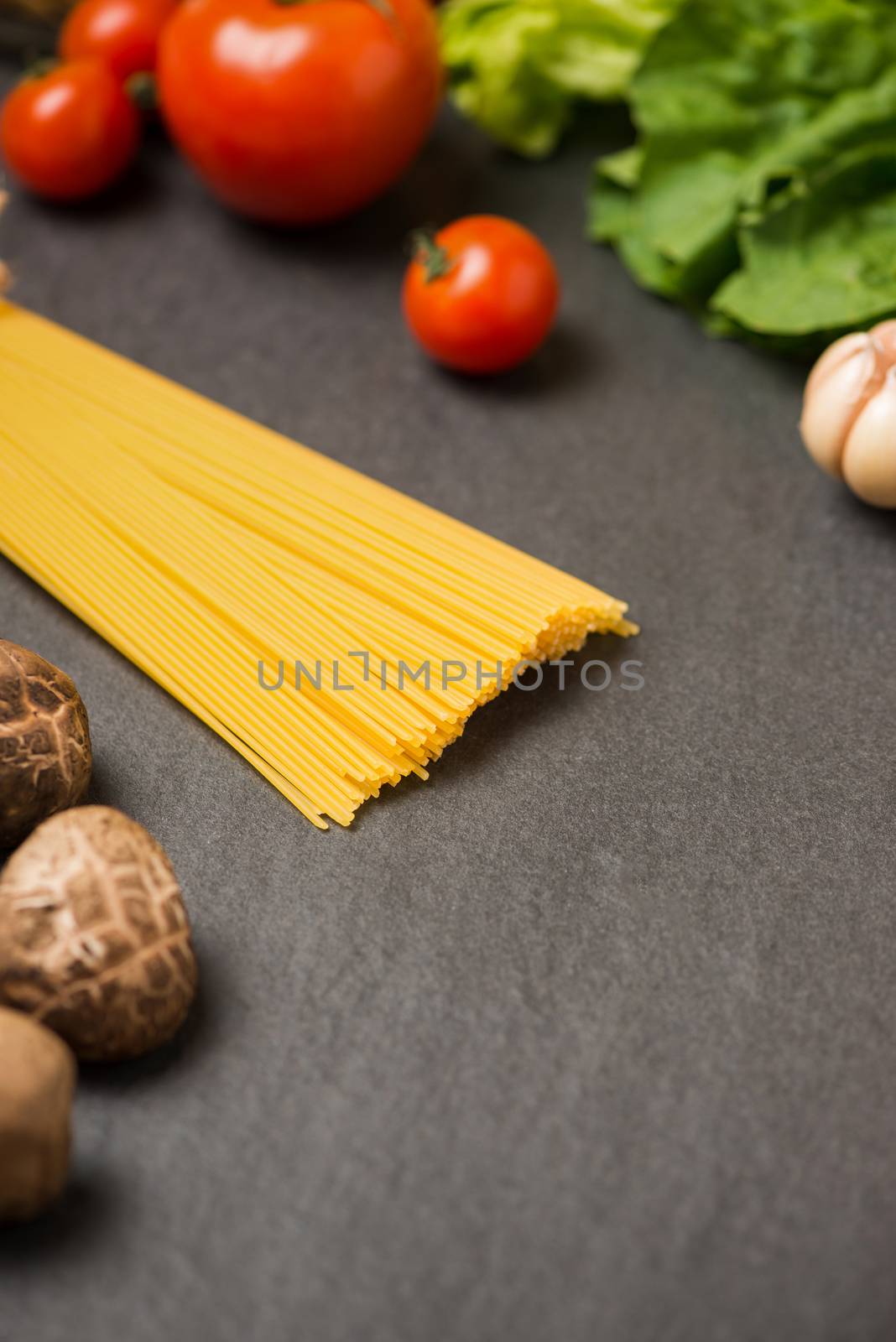 Italian food concept. Pasta ingredients. Cherry-tomatoes, spaghe by makidotvn