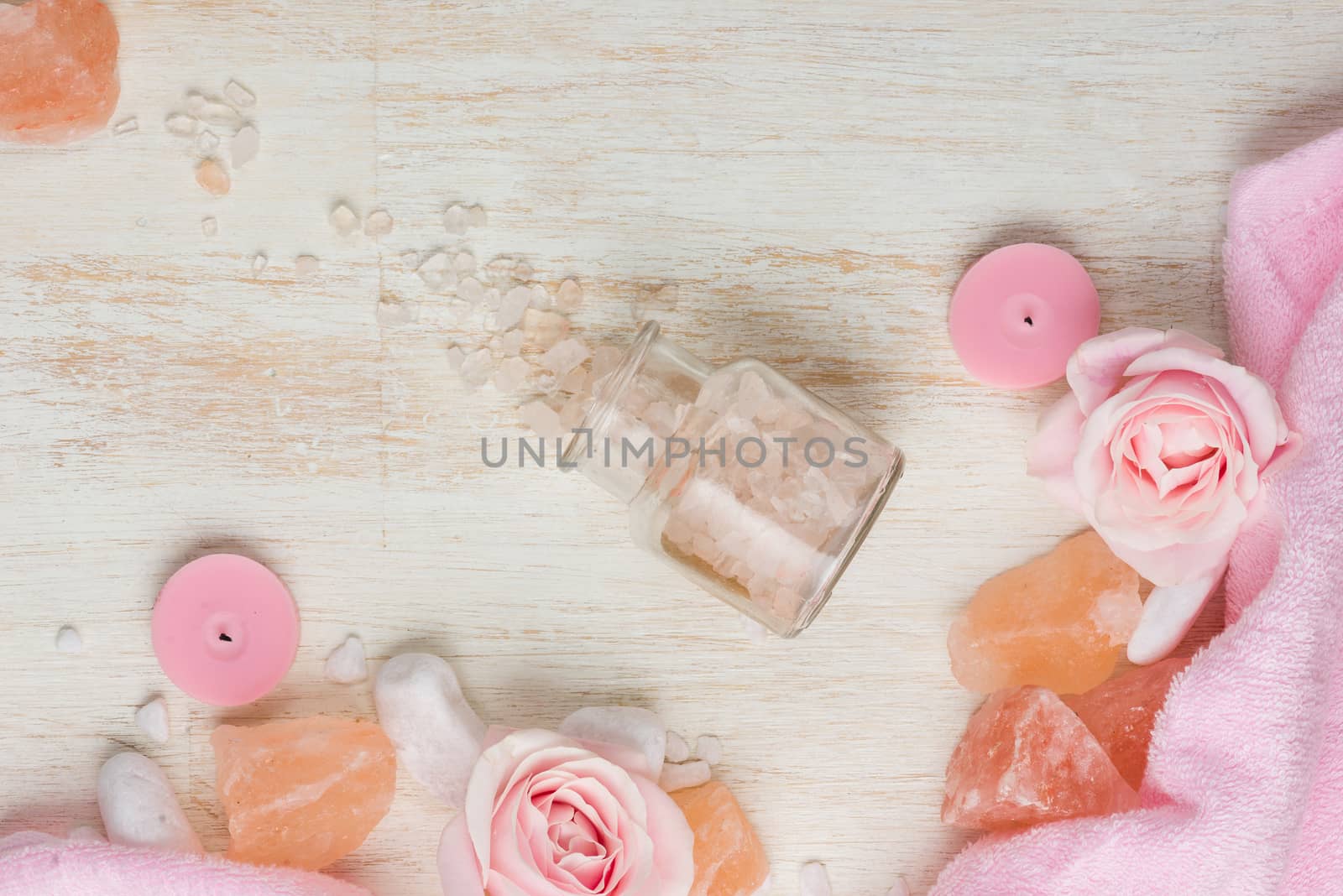 Spa settings with roses. Various items used in spa treatments on white wooden background.