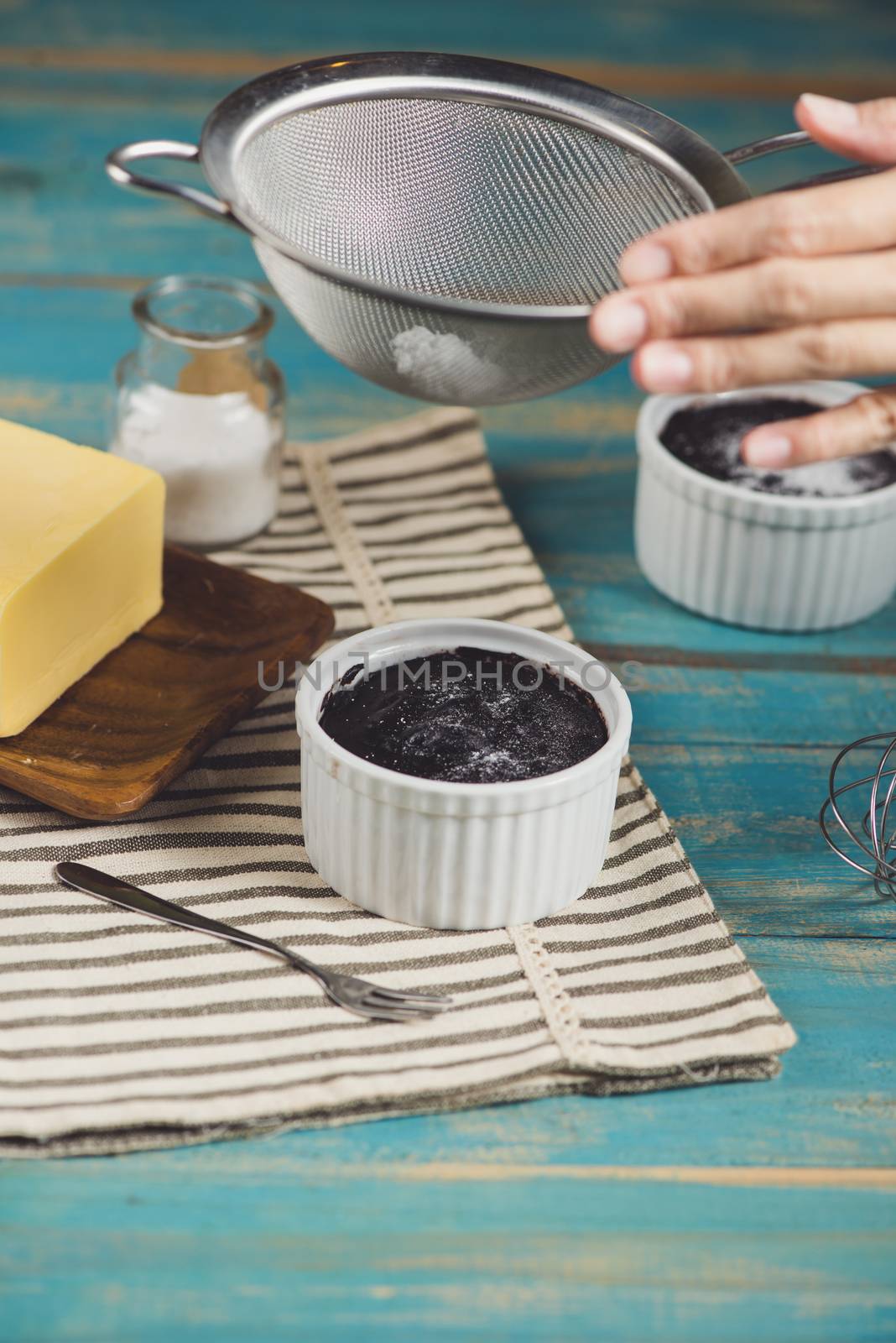 Chocolate homemade dark muffin on a blue wooden table  by makidotvn