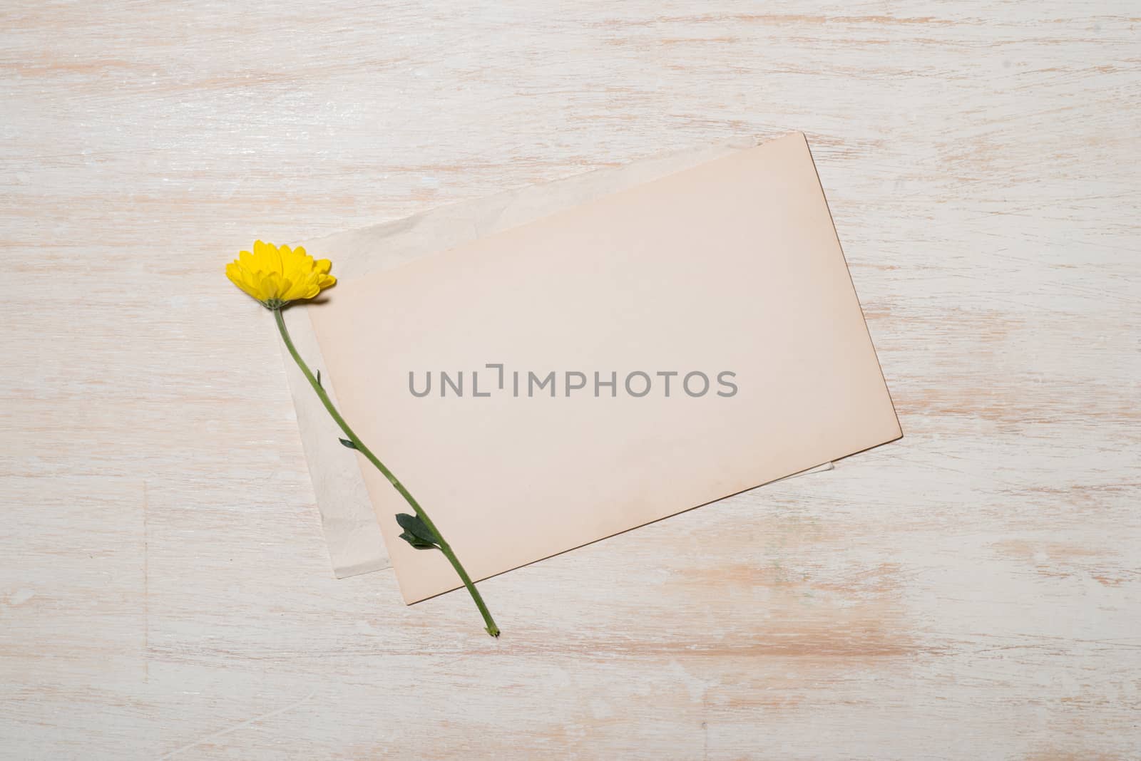 Yellow daisy bouquet on wooden table. by makidotvn