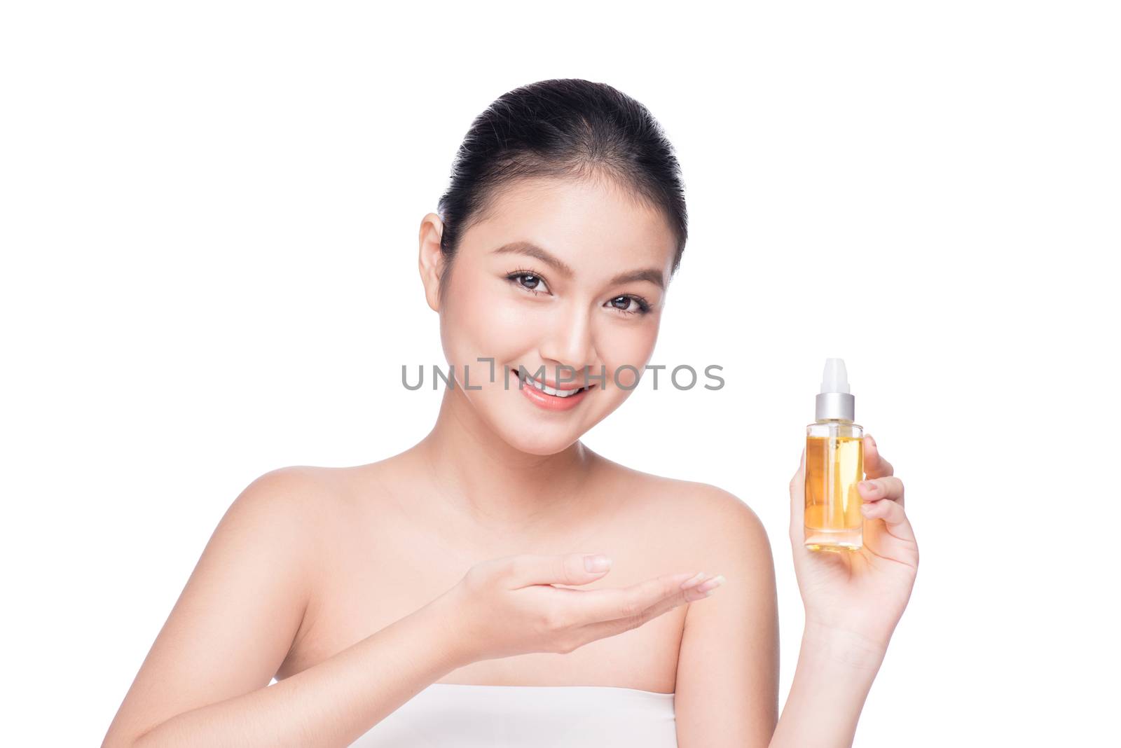 Health, spa and beauty concept. Asian woman with perfect skin holding oil bottle