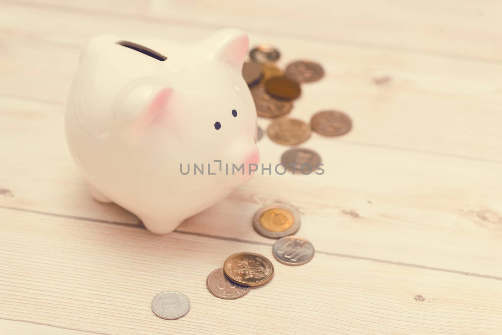 Golden coins and a pink piggy bank. Japanese Yen.