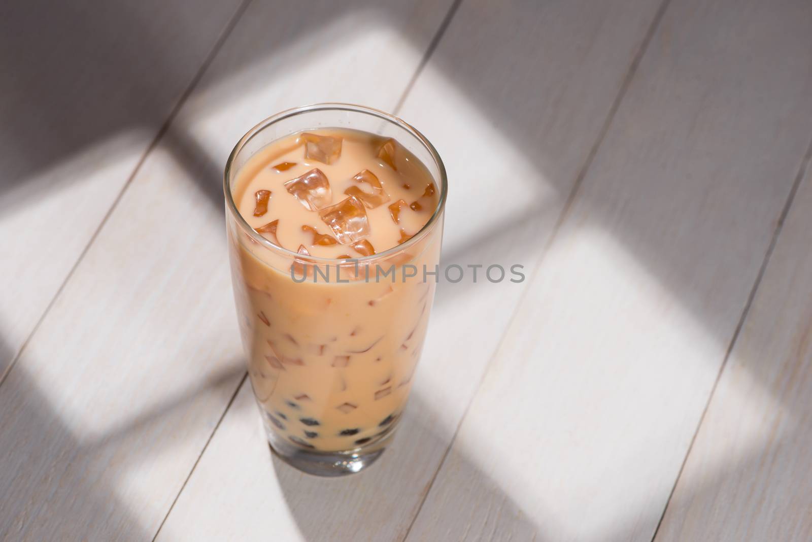 Boba / Bubble tea. Homemade Chocolate Milk Tea with Pearls on wooden table.