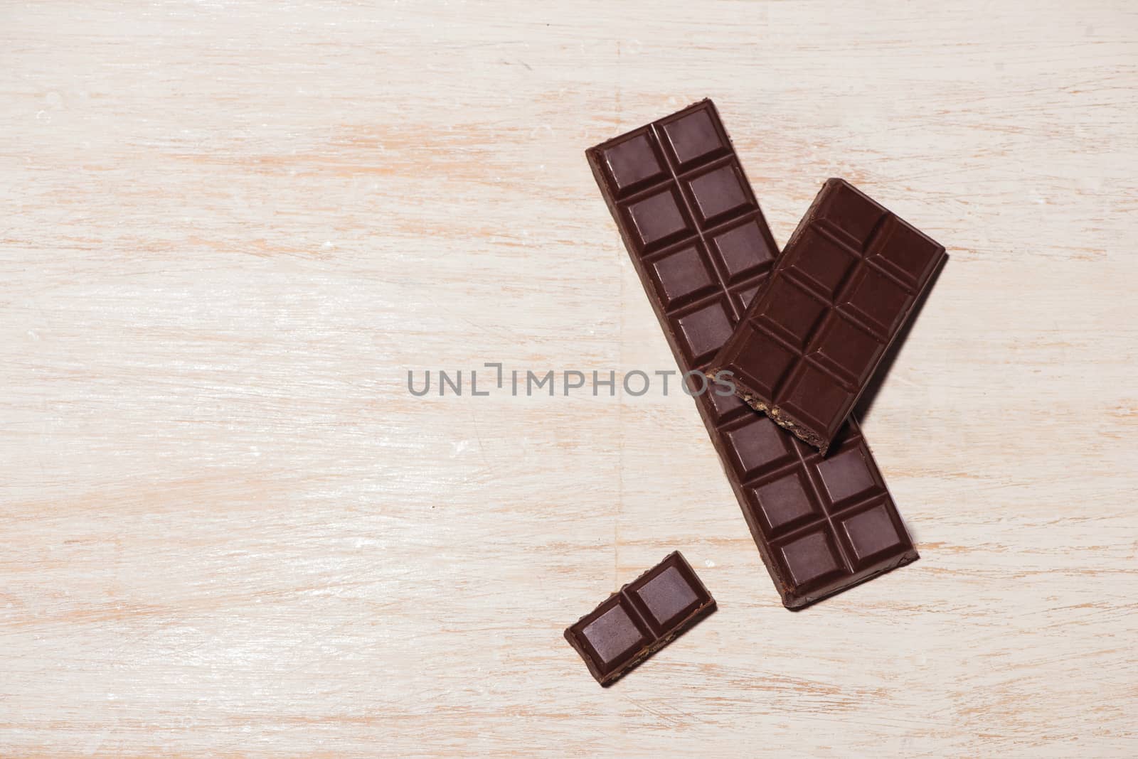 A lot of variety chocolates bar in box on white wooden background