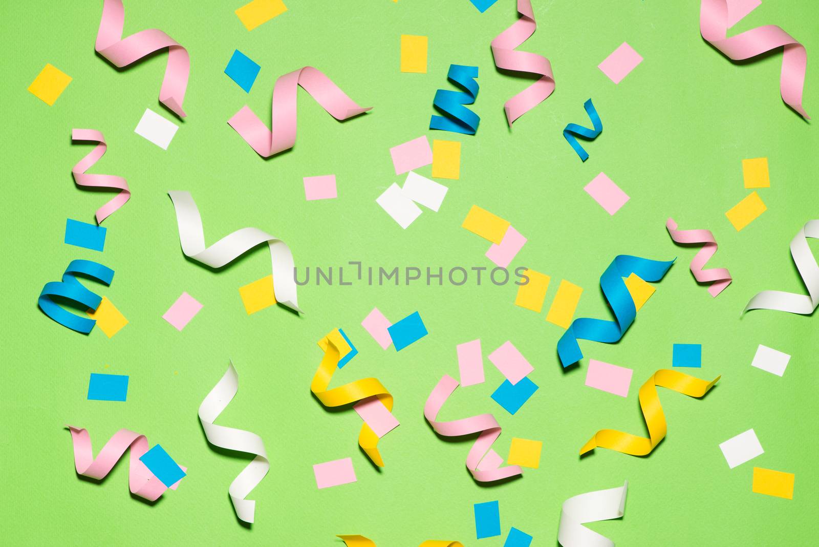 Celebration Flat lay with colorful party items on green backgrou by makidotvn