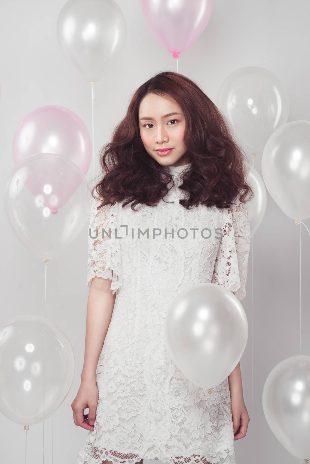 Stylish fashion asian woman with pastel balloons by makidotvn