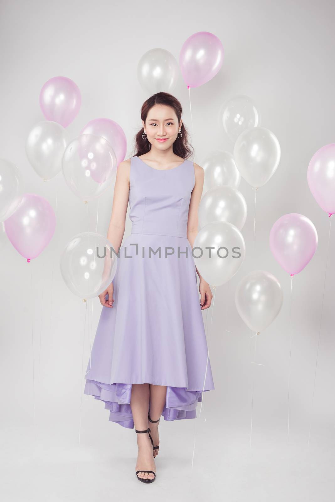 Full-length of fashion photo of beautiful woman with pastel ball by makidotvn