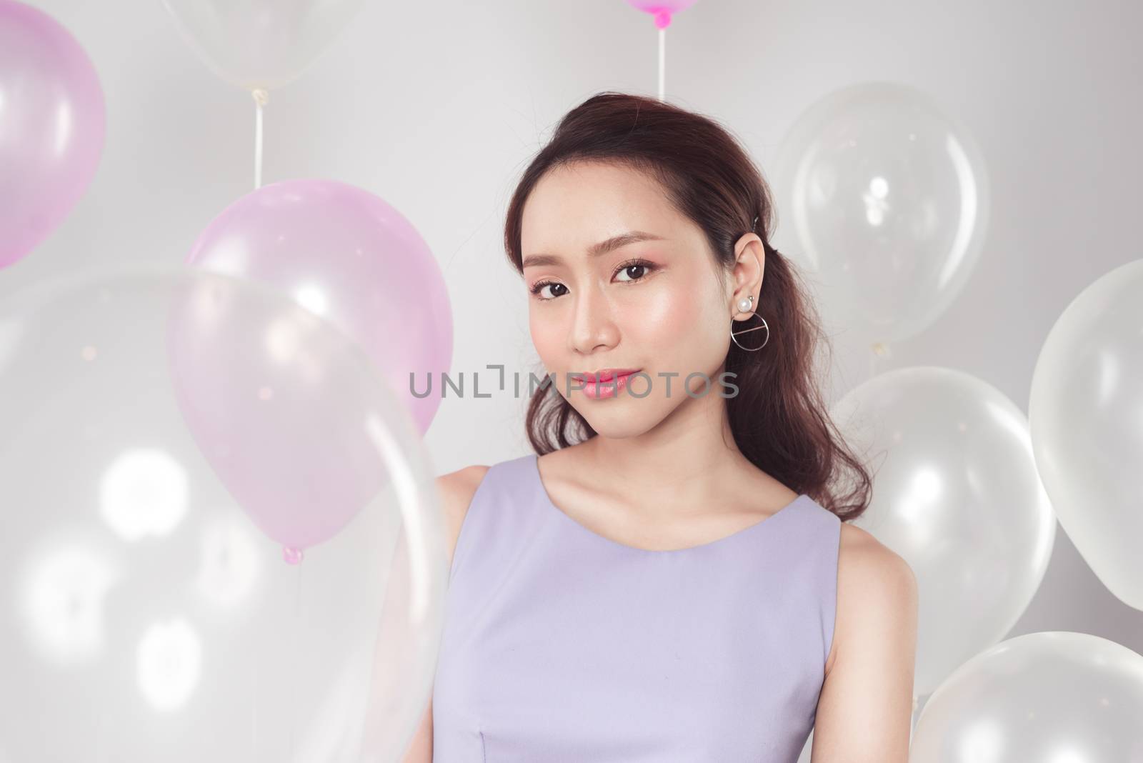 Stylish beautiful asian woman with pastel balloons by makidotvn