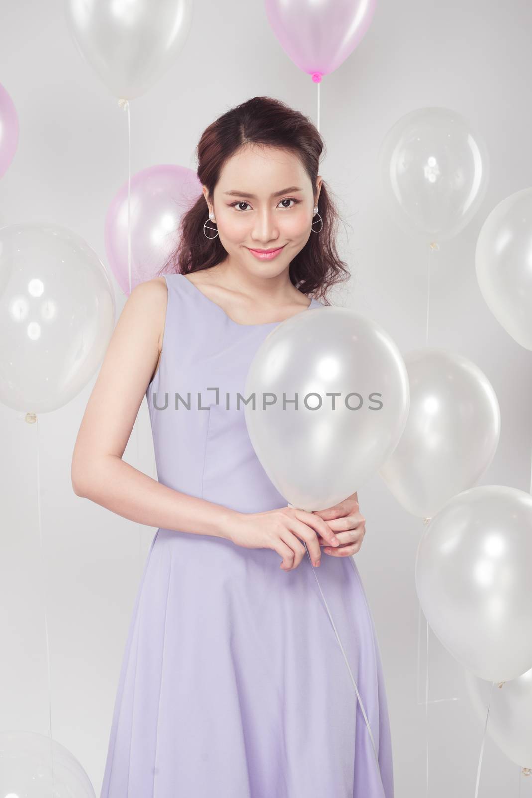 Stylish beautiful asian woman with pastel balloons by makidotvn