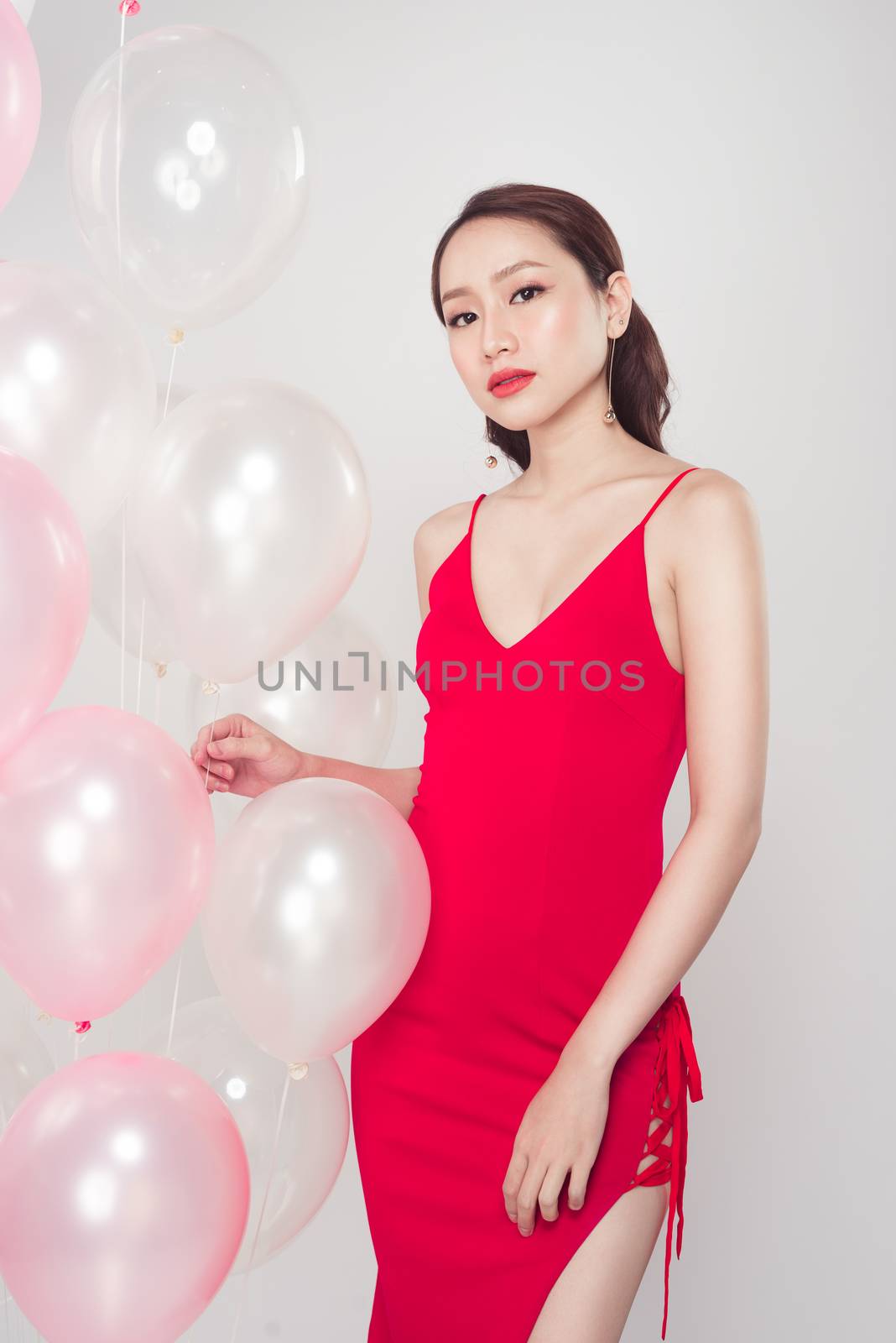 Stylish beautiful asian woman with pastel balloons by makidotvn